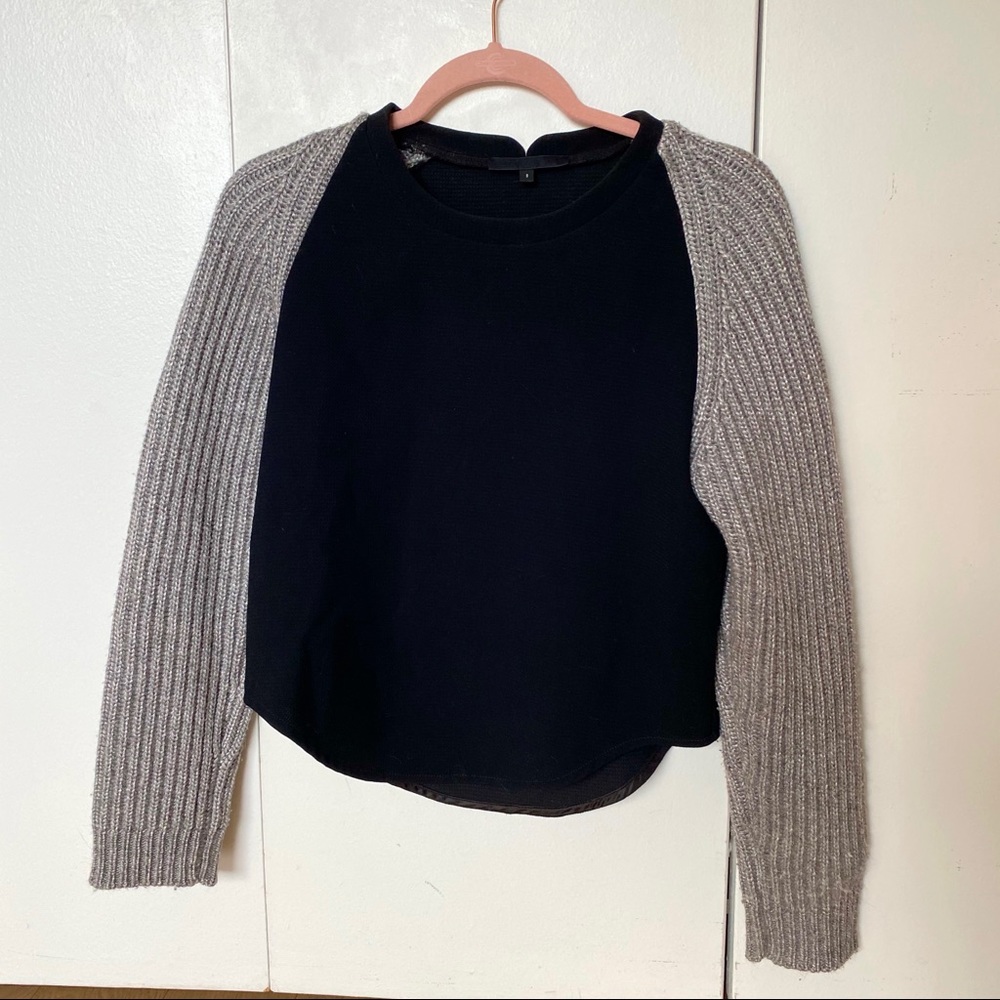 Black sweater with cable knit sleeves